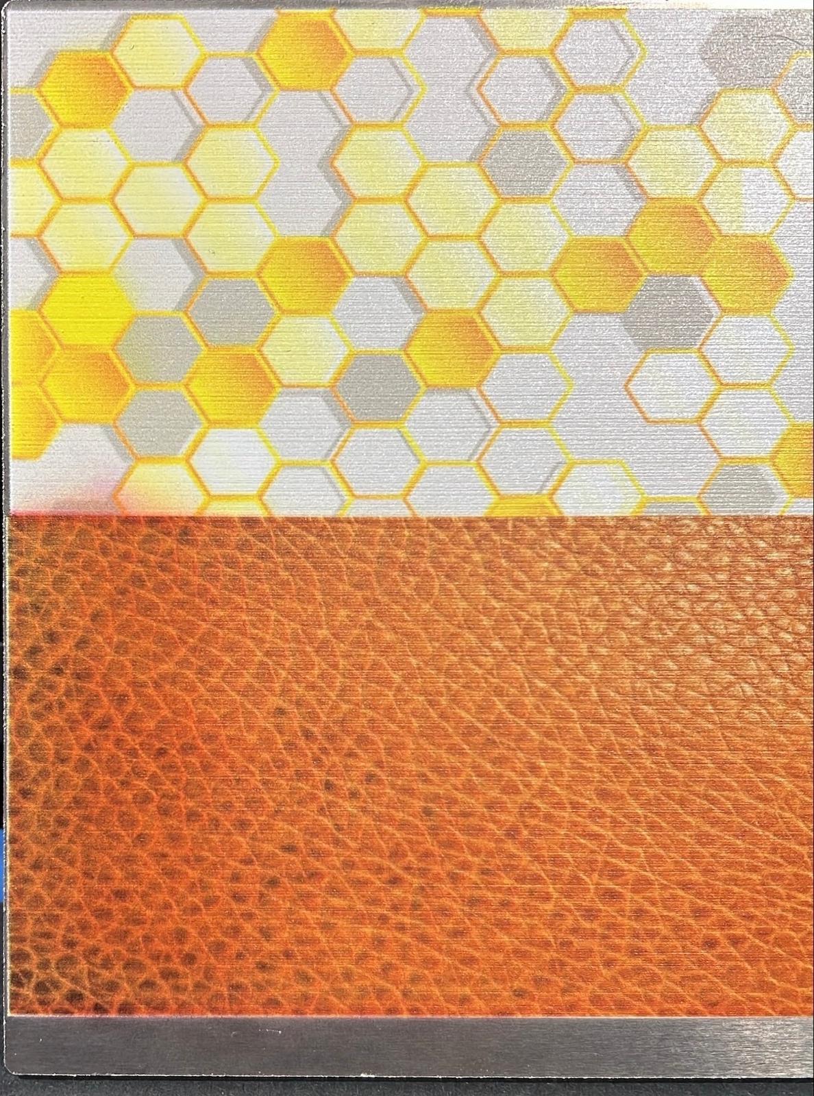 Abstract geometric artwork above and a leather appearance below, both UV-printed directly onto aluminum.